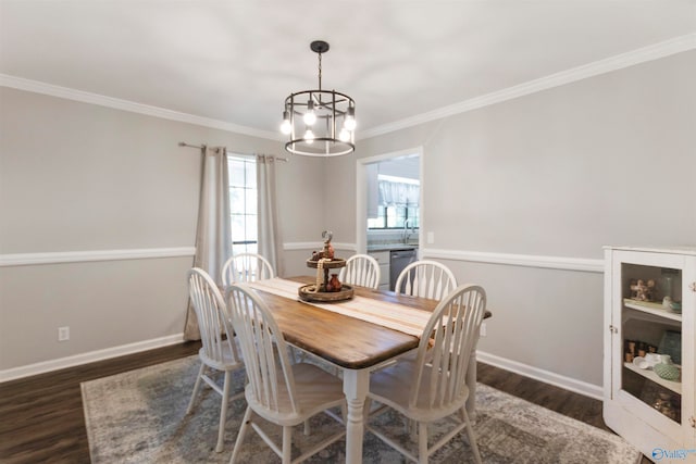 dining space featuring dark hardwood / wood-style flooring, ornamental molding, and an inviting chandelier