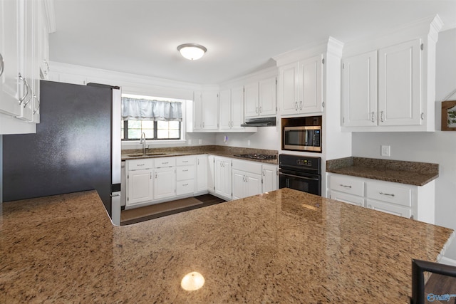 kitchen featuring kitchen peninsula, sink, white cabinets, and appliances with stainless steel finishes