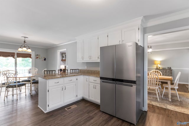 kitchen featuring white cabinetry, kitchen peninsula, stainless steel fridge, and dark hardwood / wood-style floors