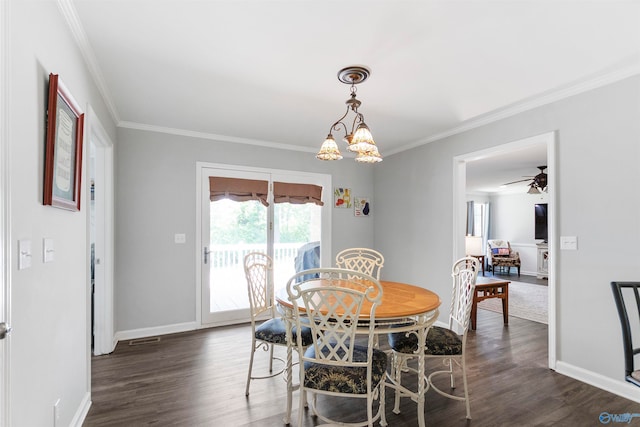 dining room featuring dark wood-type flooring, ceiling fan with notable chandelier, and ornamental molding