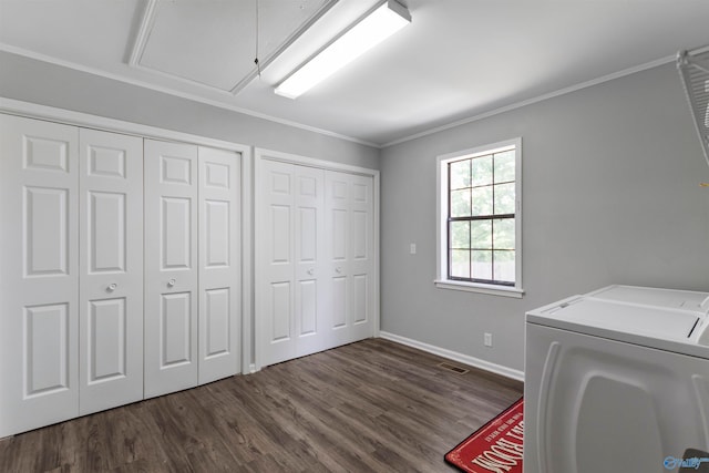 clothes washing area featuring washing machine and dryer, crown molding, and dark wood-type flooring