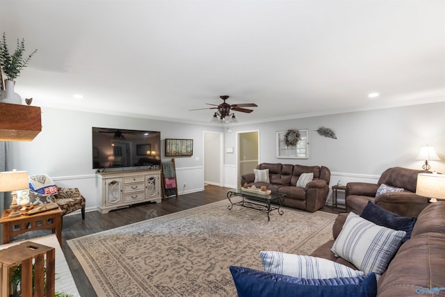 living room with ceiling fan, crown molding, and dark wood-type flooring