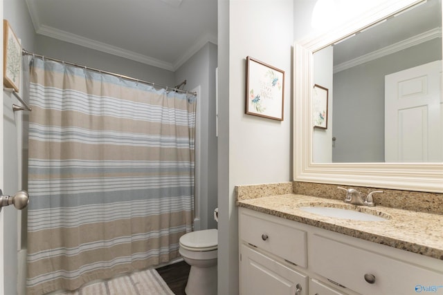 bathroom featuring vanity, toilet, and ornamental molding