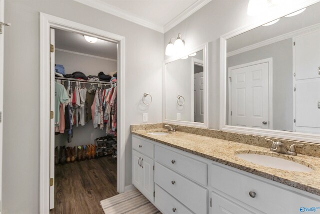 bathroom with vanity, ornamental molding, and hardwood / wood-style flooring