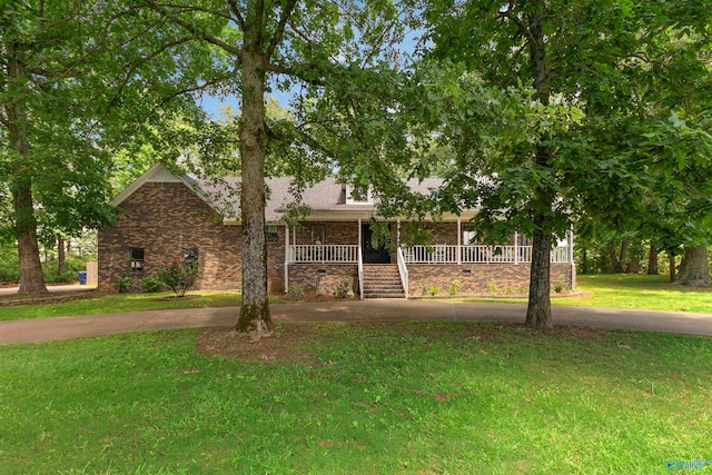 view of front of property with covered porch and a front yard