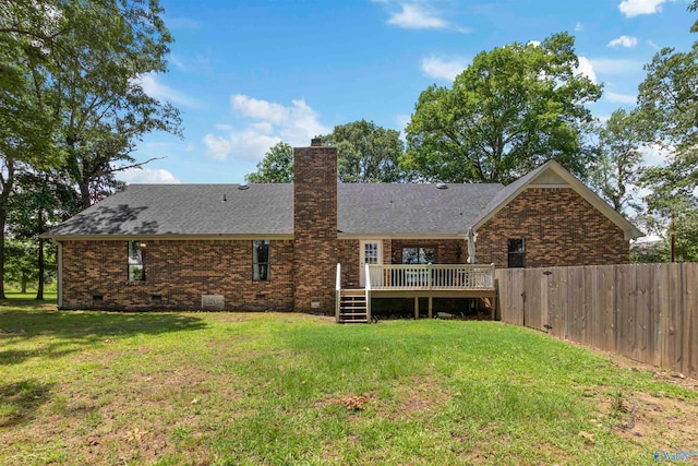 back of house with a lawn and a wooden deck