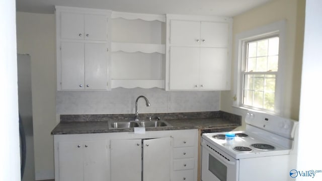 kitchen featuring white cabinetry, sink, white electric range, and a wealth of natural light