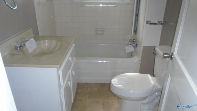 full bathroom with vanity, tiled shower / bath combo, and toilet