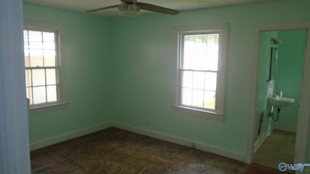 unfurnished room featuring a wealth of natural light and ceiling fan