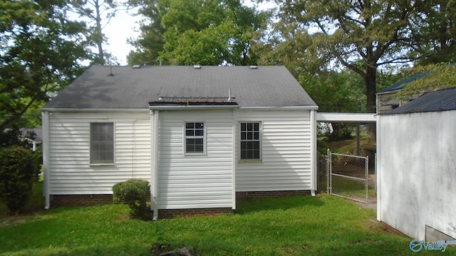 rear view of house with a lawn