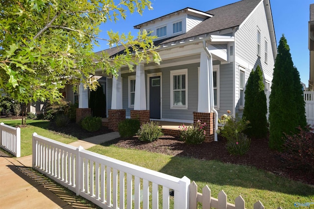 craftsman-style home featuring a front lawn and cooling unit