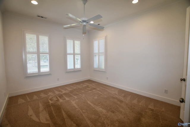 spare room featuring carpet, ornamental molding, and ceiling fan