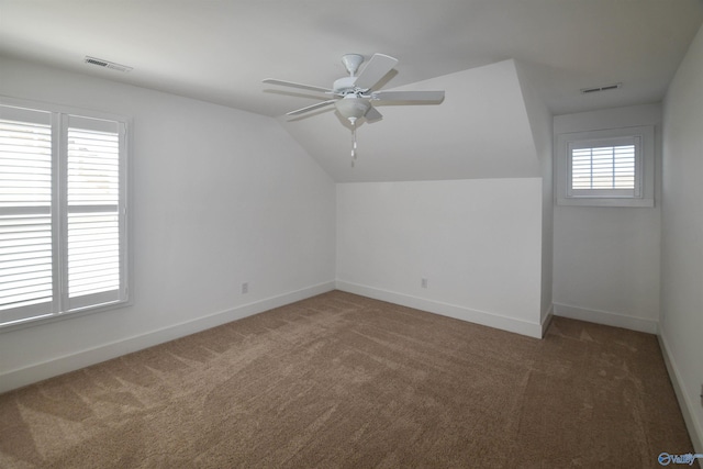 additional living space with ceiling fan, vaulted ceiling, and carpet