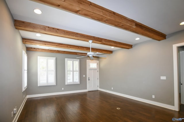 empty room featuring ceiling fan, beamed ceiling, and dark wood-type flooring