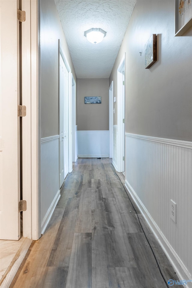 207 Sharp Dr, Gadsden, AL 35903 - hall with wainscoting, wood finished floors, and a textured ceiling
