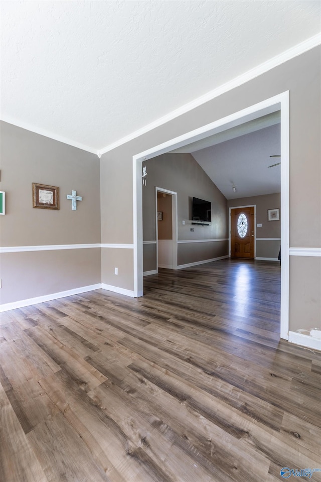 207 Sharp Dr, Gadsden, AL 35903 - unfurnished living room featuring lofted ceiling, wood finished floors, and baseboards