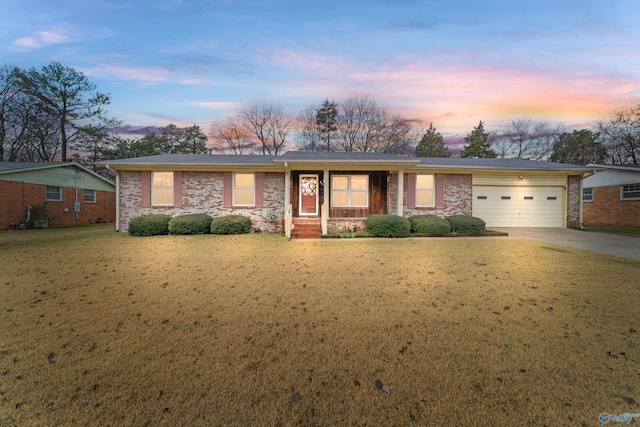 single story home with a yard and a garage