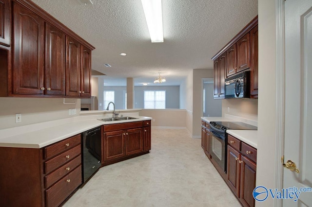 kitchen featuring a textured ceiling, black appliances, sink, kitchen peninsula, and a chandelier