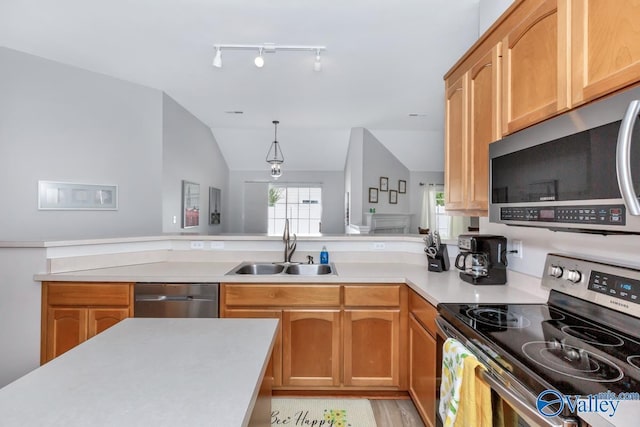 110 SW Cotton Bend Dr, Huntsville, AL 35824 - kitchen with appliances with stainless steel finishes, a sink, light countertops, lofted ceiling, and a peninsula