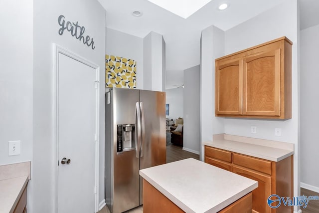 110 SW Cotton Bend Dr, Huntsville, AL 35824 - kitchen with stainless steel fridge, light countertops, a center island, wood finished floors, and baseboards