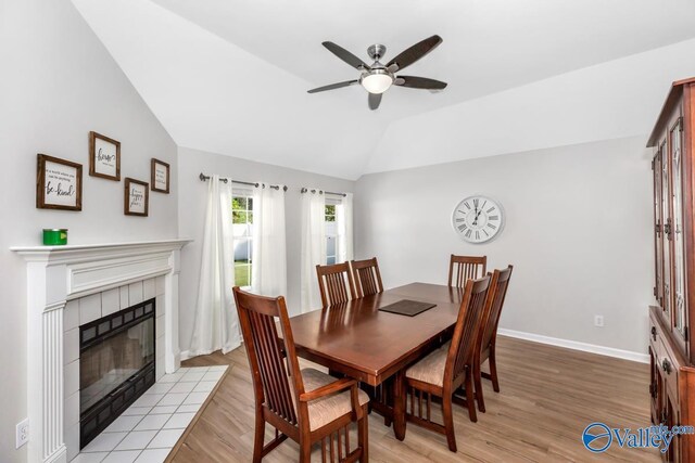 110 SW Cotton Bend Dr, Huntsville, AL 35824 - dining area featuring lofted ceiling, ceiling fan, light wood-type flooring, a fireplace, and baseboards