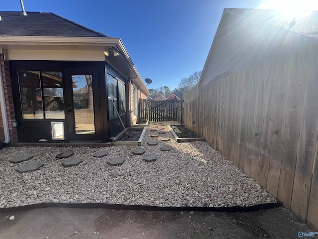 view of property exterior with a fenced backyard and a shingled roof