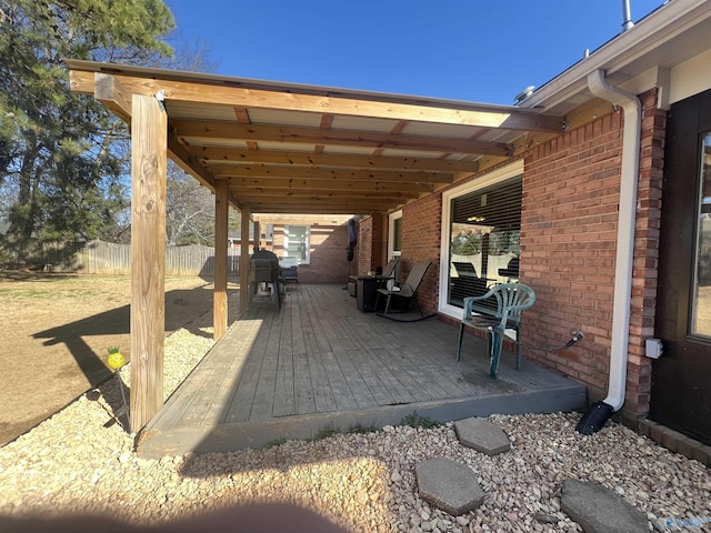 view of patio / terrace with a wooden deck and fence