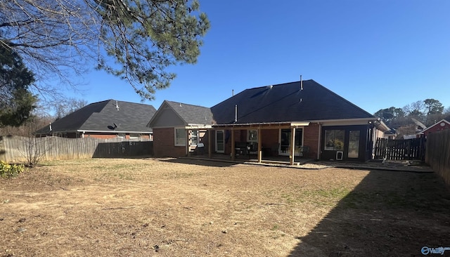 rear view of property with a fenced backyard