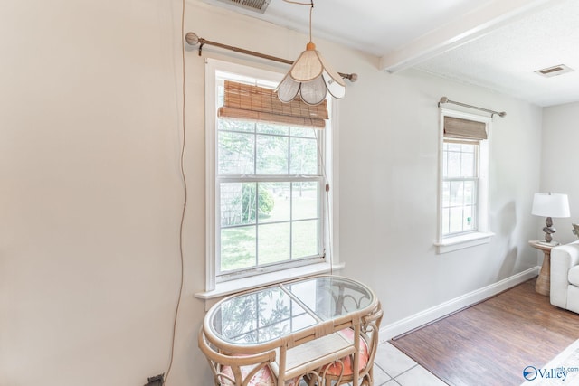 3516 Oleander Rd SW, Huntsville, AL 35805 - dining space with visible vents, baseboards, beam ceiling, and wood finished floors