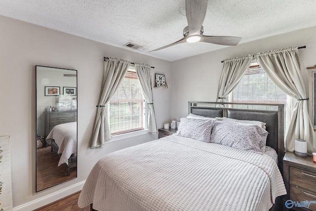 3516 Oleander Rd SW, Huntsville, AL 35805 - bedroom featuring baseboards, multiple windows, wood finished floors, and visible vents
