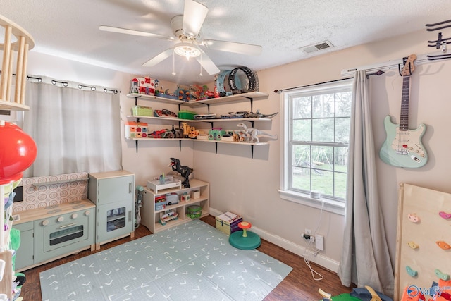 3516 Oleander Rd SW, Huntsville, AL 35805 - recreation room featuring ceiling fan, a textured ceiling, visible vents, wood finished floors, and baseboards