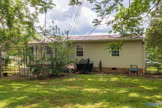 3516 Oleander Rd SW, Huntsville, AL 35805 - back of house featuring a yard, crawl space, and metal roof