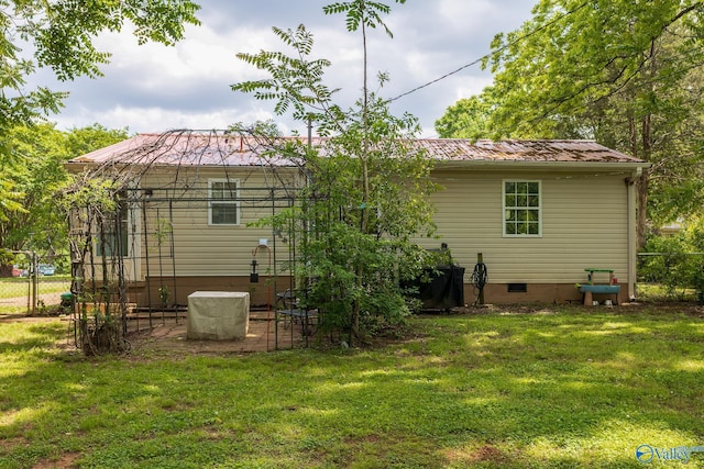 3516 Oleander Rd SW, Huntsville, AL 35805 - back of property featuring a lawn, fence, crawl space, and metal roof