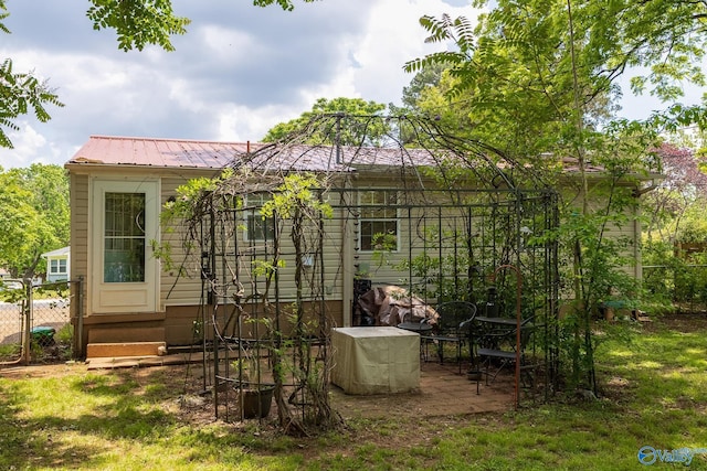 3516 Oleander Rd SW, Huntsville, AL 35805 - back of house featuring fence, metal roof, and entry steps