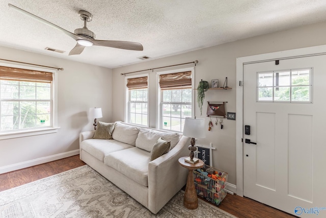 3516 Oleander Rd SW, Huntsville, AL 35805 - living area featuring ceiling fan, a textured ceiling, baseboards, wood finished floors, and visible vents