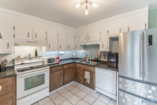 3516 Oleander Rd SW, Huntsville, AL 35805 - kitchen featuring a sink, dark countertops, under cabinet range hood, and white appliances