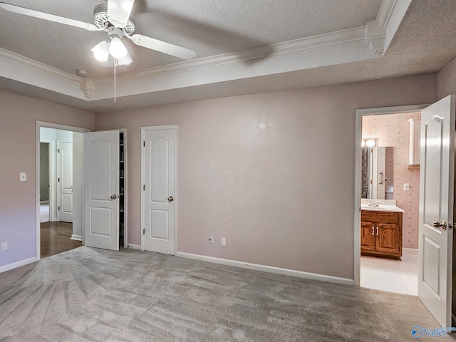 unfurnished bedroom with a textured ceiling, ceiling fan, and light carpet