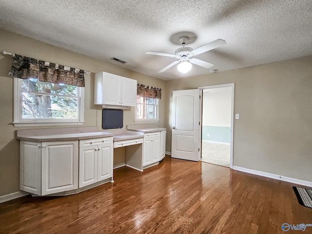 kitchen featuring white cabinetry, ceiling fan, dark hardwood / wood-style floors, and plenty of natural light