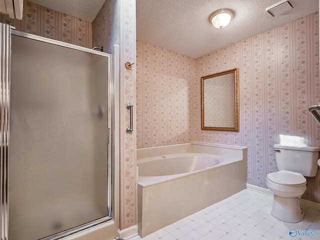 bathroom featuring a textured ceiling, shower with separate bathtub, tile patterned flooring, and toilet