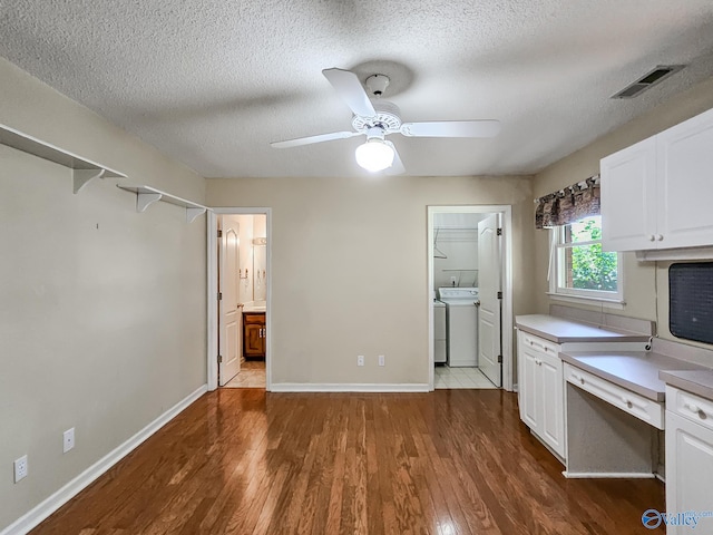 kitchen with ceiling fan, white cabinets, a textured ceiling, washer / dryer, and dark hardwood / wood-style flooring