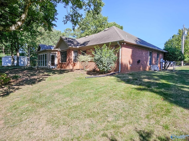 view of side of home featuring a lawn