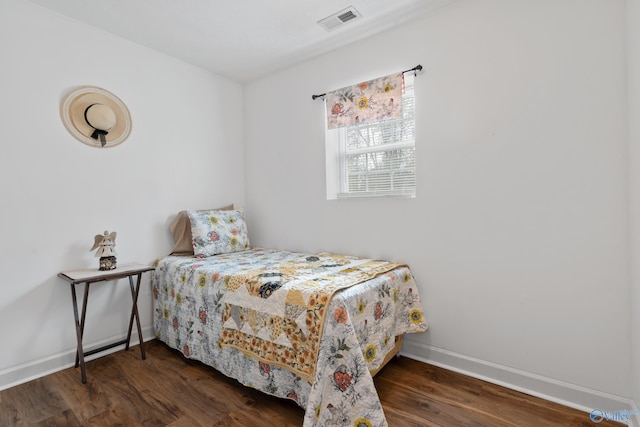 bedroom featuring dark hardwood / wood-style flooring