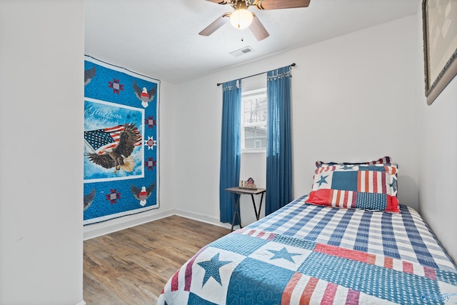 bedroom with hardwood / wood-style floors and ceiling fan