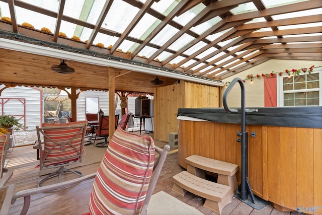 exterior space with a hot tub and a wooden deck