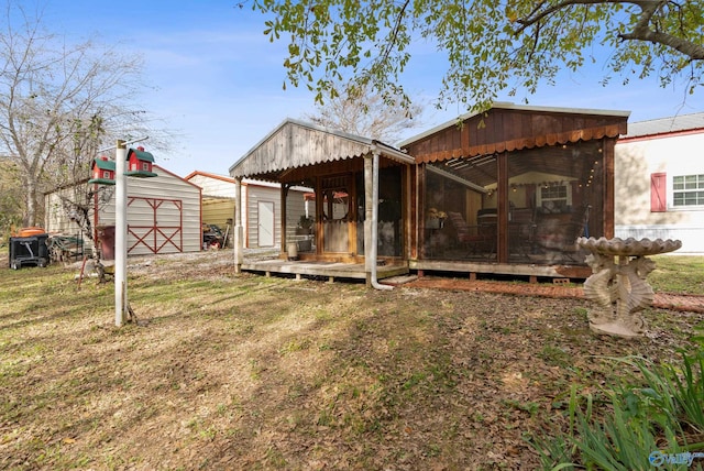 back of house featuring a yard and a shed