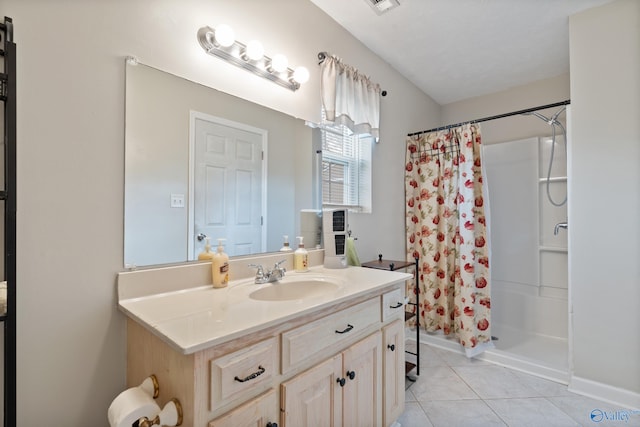 bathroom featuring tile patterned flooring, vanity, and curtained shower