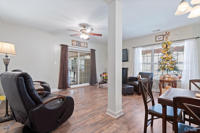 living room featuring ornate columns, ceiling fan, and hardwood / wood-style flooring