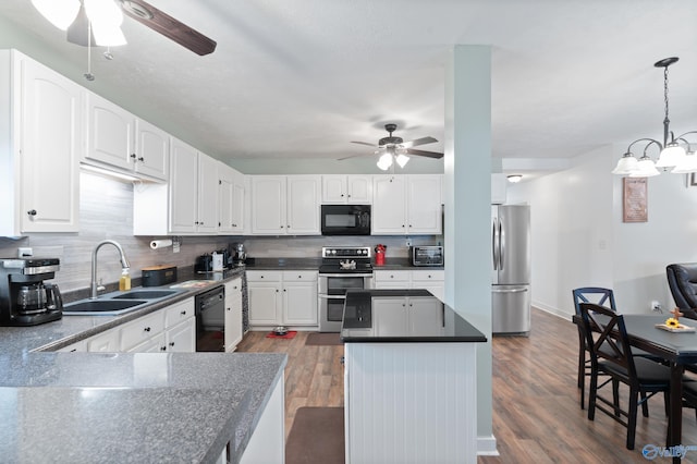 kitchen with black appliances, white cabinets, sink, decorative light fixtures, and dark hardwood / wood-style flooring