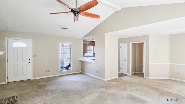 interior space featuring baseboards, beamed ceiling, visible vents, and light colored carpet