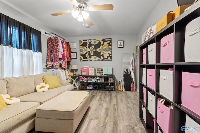 living area with ceiling fan and hardwood / wood-style floors